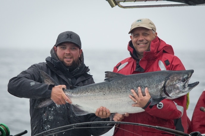2 guys holding a big fish at Peregrine Fishing Lodge